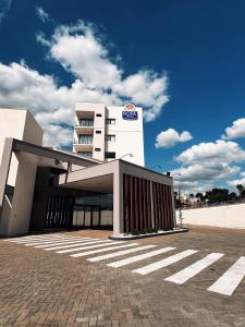 a building with a building with a sign on it at Rota Hotéis Rio Verde in Rio Verde