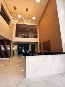 an empty lobby with a large white marble counter at Rota Hotéis Rio Verde in Rio Verde