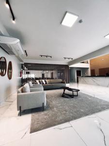 a living room with a couch and a table at Rota Hotéis Rio Verde in Rio Verde