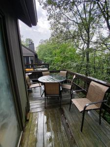 a deck with chairs and a table and a piano at Rustic Mountain Escape Waterpark, Ski & Views! in Tannersville