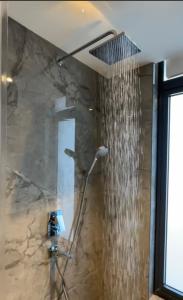 a shower in a bathroom with a shower curtain at Stellar City Apartment at Solaris in Accra