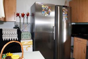 a kitchen with a stainless steel refrigerator with magnets at Central London rooms in London