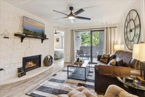 a living room with a couch and a fireplace at Modern Condo, W Fireplace & Pool In Gatlinburg! in Gatlinburg