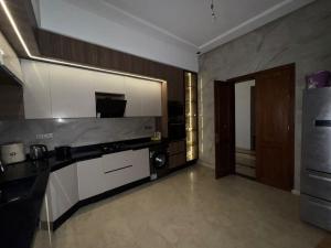 a room with a kitchen with a stove and a door at villas d'or in Marrakesh
