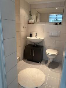 a bathroom with a sink and a toilet at Stadtnest in Bad Wildungen +3 photos