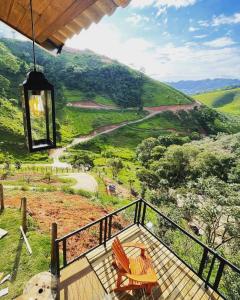 a balcony with chairs and a view of a mountain at TerraViva Glamping in Gonçalves