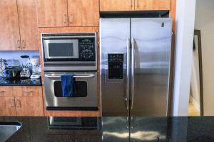 a kitchen with a stainless steel refrigerator and a microwave at 1800 Sq Ft Loft Downtown Near Convention Center in Indianapolis