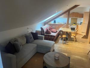 a living room with a couch and a table at Gästehaus Högerhof in Hopfgarten im Brixental +12 photos