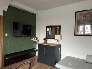 A television and/or entertainment centre at Péterfia Boutique Apartments