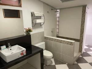 un bagno con un water bianco e un lavandino di Iquitos Confort a Iquitos