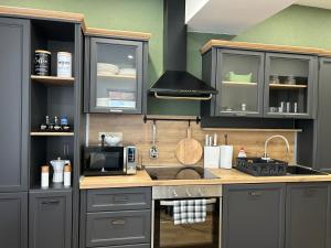 A kitchen or kitchenette at Péterfia Boutique Apartments