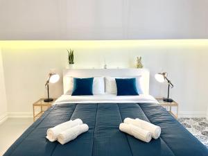 a bedroom with a large bed with two towels on it at Lecce Diamond - 200mq in centro città con terrazza privata in Lecce