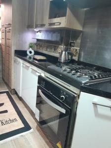 a kitchen with a stove with a tea kettle on it at Quiet Living in Cairo
