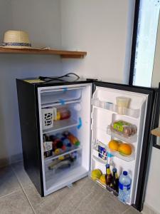 a refrigerator with its door open in a kitchen at Capibara-Glamping Cabaña in La Mesa