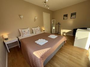 a bedroom with a bed with two towels on it at R-Joki Apartments in Ravijoki