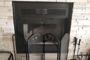 a fireplace with two chairs in front of it at WOW Location Incredible Views in Osage Beach