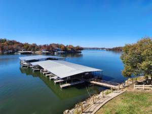 a dock on a body of water at Lake Life reimagined Margarita Sunsets 17MM in Osage Beach