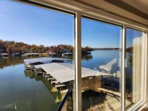 a reflection of a dock in the windows of a house at Lake Life reimagined Margarita Sunsets 17MM in Osage Beach +86 photos