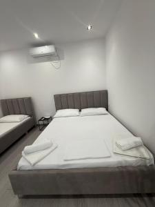 a bedroom with a large white bed in it at Vacation rooms in Vlorë