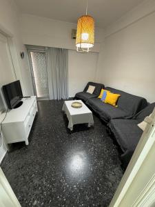 a living room with a couch and a table at EVE'S HOUSE 2 in FRONT OF THE BEACH in Loutraki +8 photos