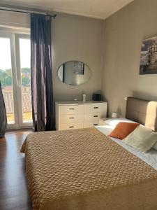 a bedroom with a large bed and a mirror at casa mioara in Montefiascone