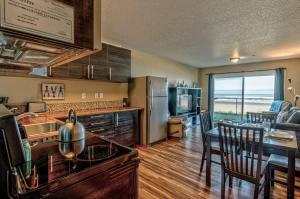 Una cocina y una sala con una mesa y un comedor. en Modern Ground Floor Beachfront Condo Suite - Sleeps 4 - Pool and Sauna, en Lincoln City