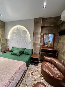 a bedroom with a bed and a chair at Golden Luxury Elite Studio Downtown in Aswan +11 photos