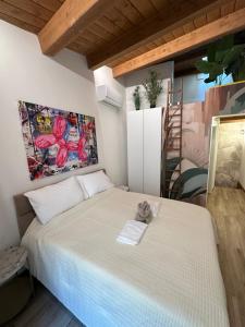 a bedroom with a bed with a teddy bear on it at Aurea Dimora Picena in Ascoli Piceno