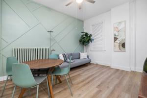 a dining room with a table and chairs and a couch at Downtown Adams in Sandusky