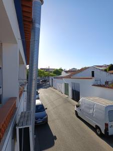 two cars parked in a parking lot next to a building at A Casa da Cilarca in Portel +19 photos