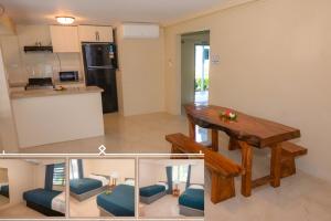 una cucina e un soggiorno con un tavolo di legno in una stanza di Grand Melanesian Resort Wailoaloa a Nadi