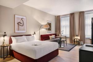 a bedroom with a large bed and a living room at VCity Suites at The Teacher in Glasgow