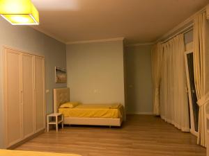 a bedroom with a bed with a yellow bedspread at Apartment in Primavera Residence in Fushë-Draç +11 photos