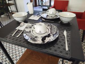 a black table with plates and bowls on it at Calma house B&B in Carovigno