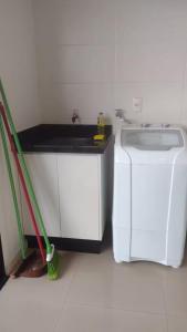 a kitchen with a sink and a washing machine at Ed Highline, piscina, lavanderia in Joinville +2 photos