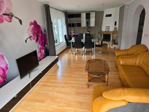a living room with a couch and a table at Willa na Ogrodowej in Długopole-Zdrój