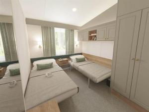 a small room with two beds and a couch at DJD ,Country Style Luxury Lodge, Manor Park Sleeps 4 in Hunstanton