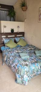 a bed with pillows on it in a bedroom at Dans la nature, villa de Standing avec piscine chauffée, jaccusi extérieur in Clermont-lʼHérault