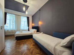 a hotel room with two beds and a window at Gaste Haus Ober in Braşov