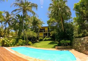 a swimming pool in front of a resort at Casa Janaina Ilhabela in Ilhabela