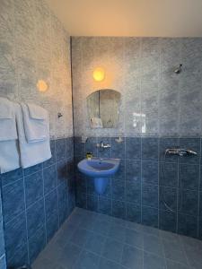 a blue bathroom with a sink and a shower at Sarievi Holiday Home in Tsarevo +71 photos