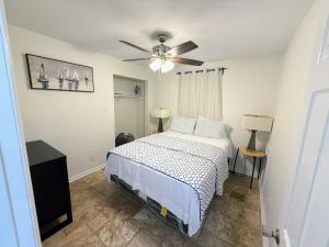 a bedroom with a bed and a ceiling fan at Renovated 2 Bedroom In Durham! Superhost! in Durham
