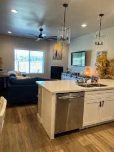 a kitchen and living room with a ceiling fan at The Cabin in Flagstaff