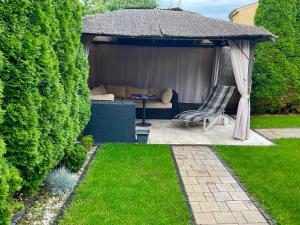 a gazebo with a couch in a garden at Charming home near old town in Košice