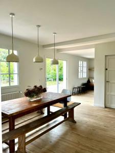 a living room with a wooden table with flowers on it at Charming House In Lyons-La-Forêt in Lyons-la-Forêt