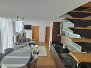 a kitchen and living room with a table and chairs at Sequeira Arantes Casa 1 in Terras de Bouro