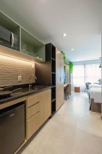 a kitchen with a sink and a stove at Cozzy Premium Paulista Hotel in Sao Paulo