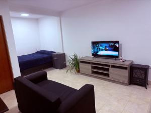 a living room with a tv and a couch at Casa Azul in La Quiaca
