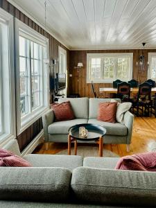 a living room with two couches and a table at Upgraded Family Cabin At Sangefjell in Ål