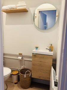 a bathroom with a sink and a mirror at Cozy studio en centre ville in Beauvais